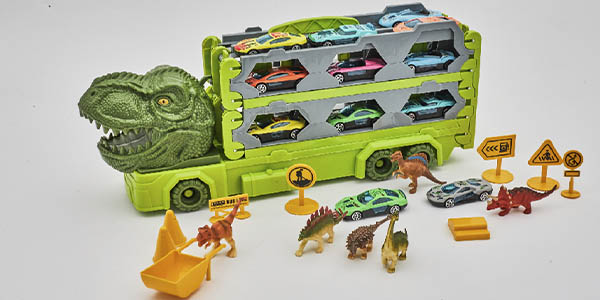 Camión Dinosaurio convertible en pista con vehículos y figuras de dinosaurios